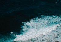 Stunning high-angle view of ocean waves crashing, showcasing nature's powerful beauty.
